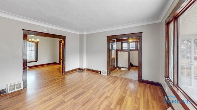 unfurnished room with visible vents, baseboards, and light wood-style floors