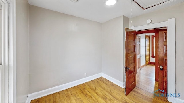 empty room featuring light wood-style floors and baseboards