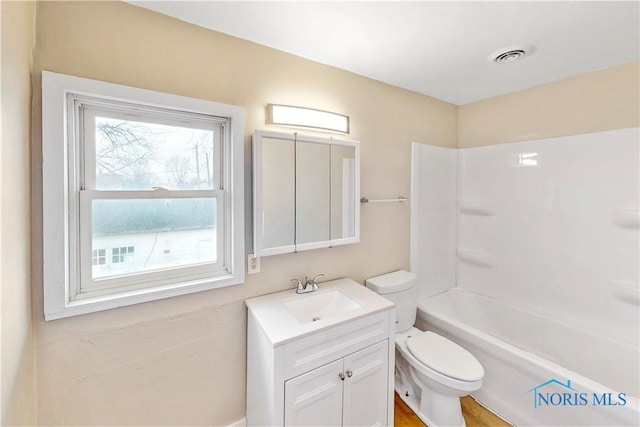 bathroom with vanity, shower / bathing tub combination, toilet, and visible vents