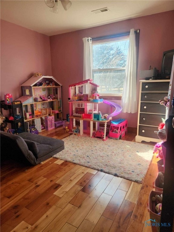 game room featuring visible vents and wood finished floors