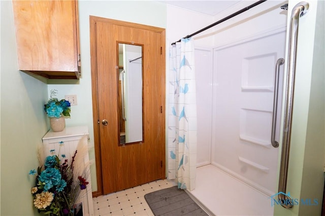 full bath with tile patterned floors and a shower with curtain