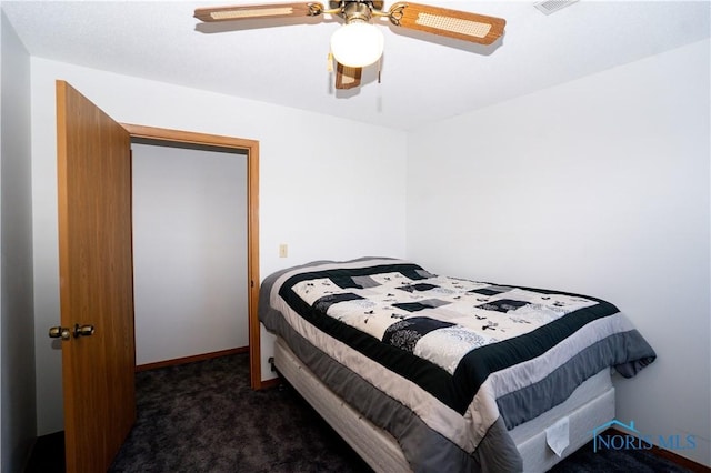 carpeted bedroom featuring baseboards and ceiling fan