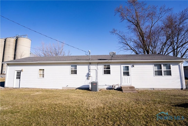 rear view of property with entry steps, a yard, central AC, and crawl space