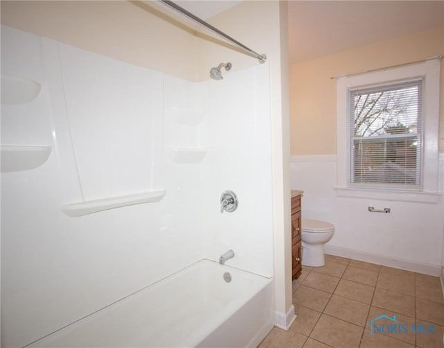 bathroom featuring tile patterned flooring, toilet, vanity, and baseboards