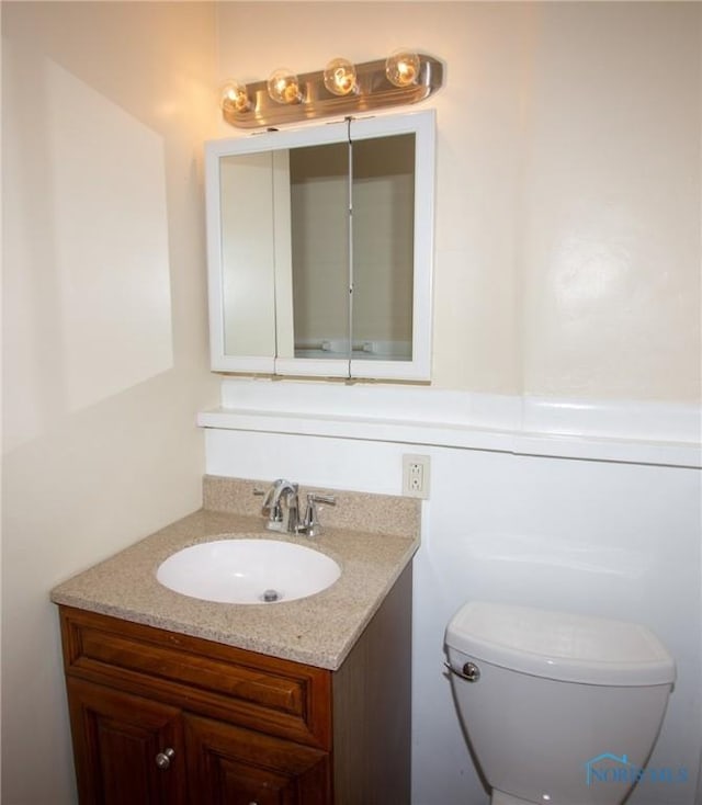 bathroom with toilet and vanity