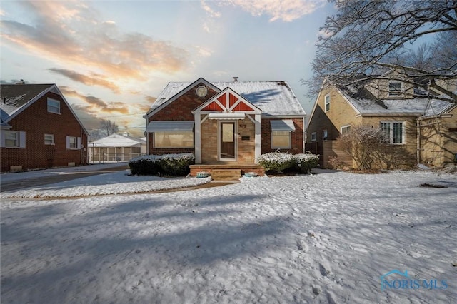 bungalow-style house with brick siding