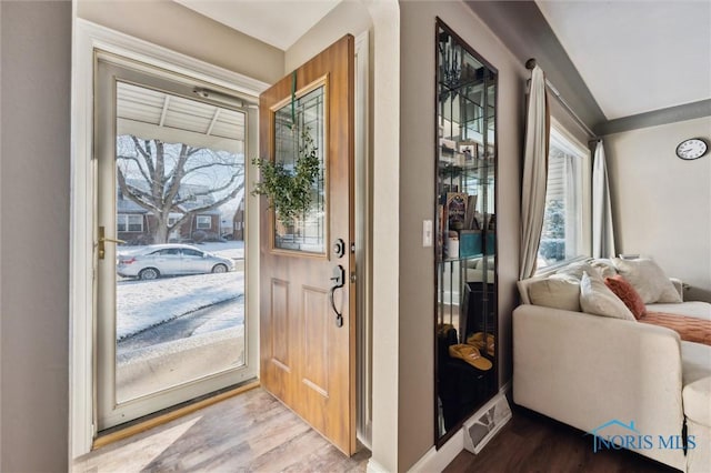 entryway with baseboards and light wood-style flooring