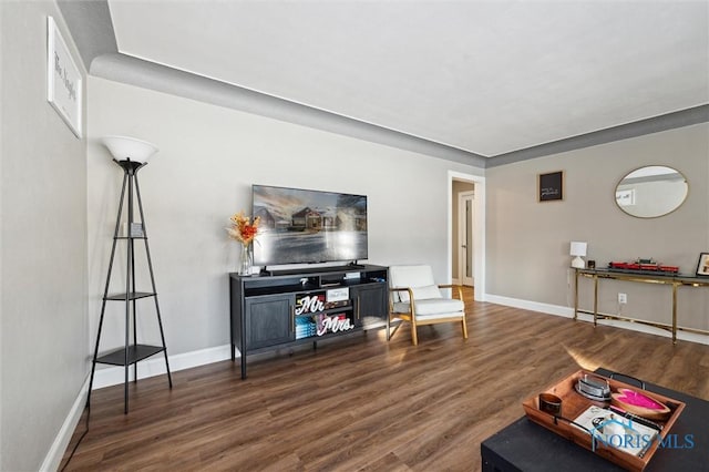 living area with wood finished floors and baseboards