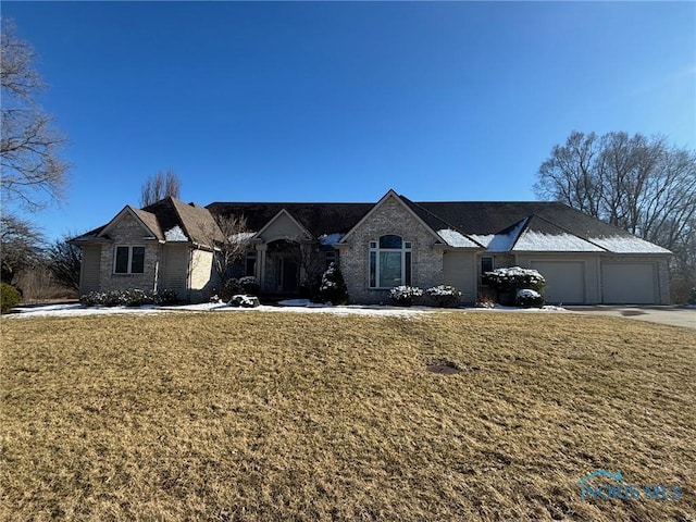 view of front of house with a garage, driveway, and a front yard