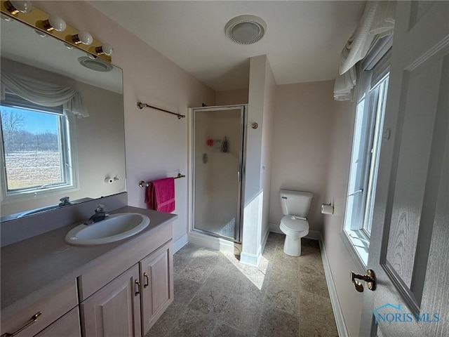 bathroom featuring baseboards, toilet, a stall shower, and vanity