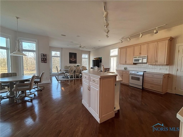 kitchen with white range with electric cooktop, dark wood-style floors, tasteful backsplash, and a sink