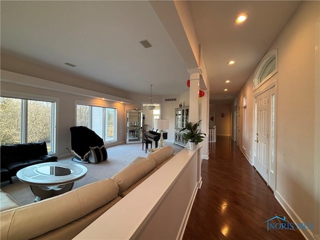 hall featuring visible vents, recessed lighting, and ornate columns