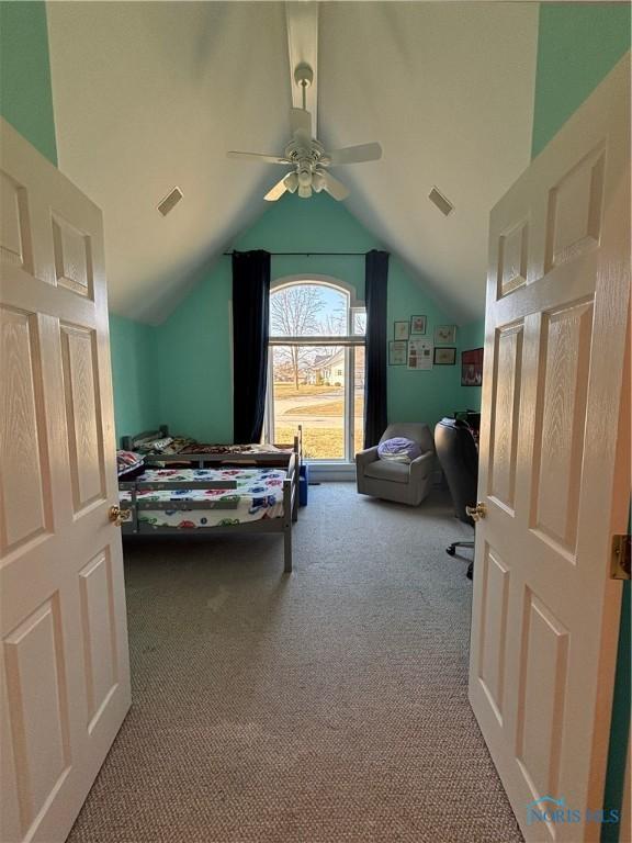 bedroom with visible vents, lofted ceiling, ceiling fan, and carpet flooring