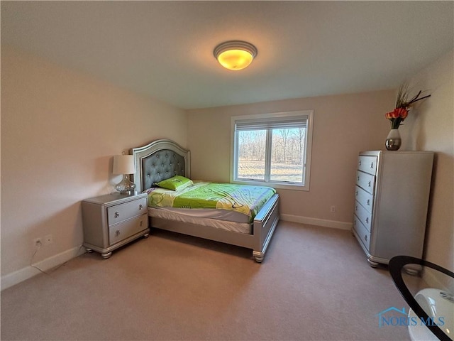 bedroom featuring baseboards and light colored carpet