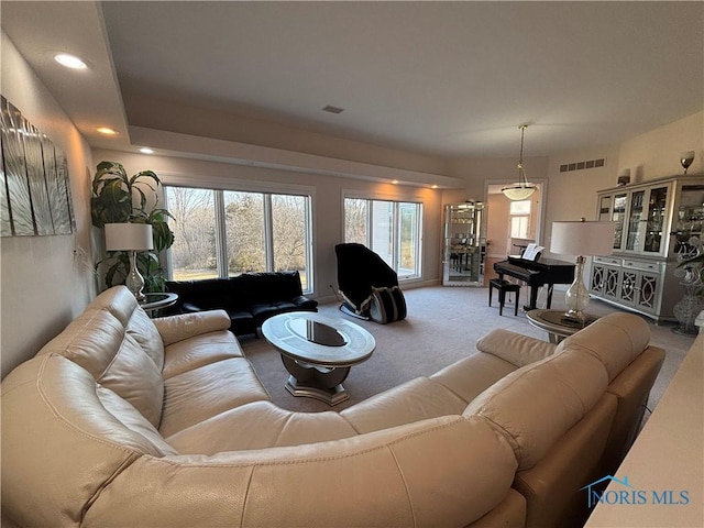 living area with visible vents, recessed lighting, and carpet floors