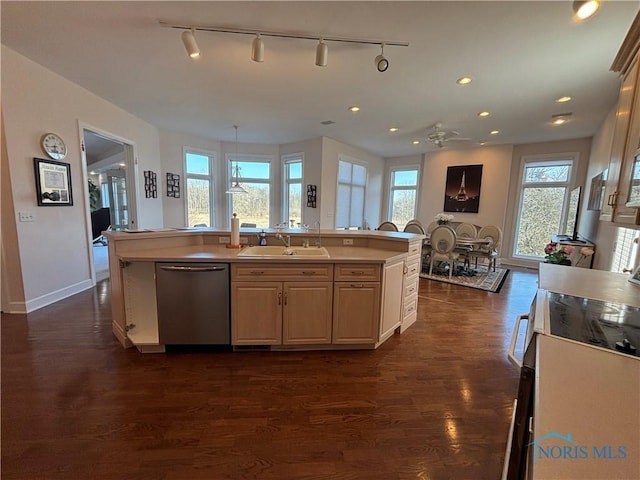 kitchen featuring a kitchen island with sink, a sink, stainless steel dishwasher, dark wood-style floors, and light countertops