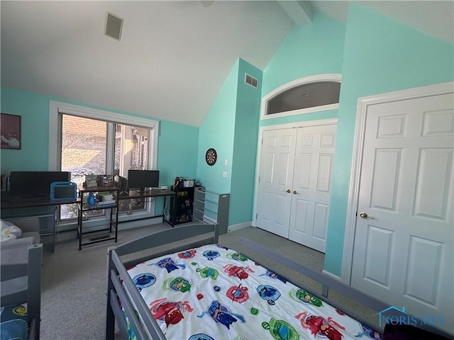 carpeted bedroom with a closet, visible vents, and lofted ceiling with beams