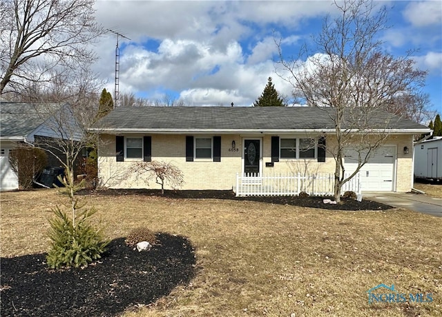 single story home with brick siding, driveway, and an attached garage