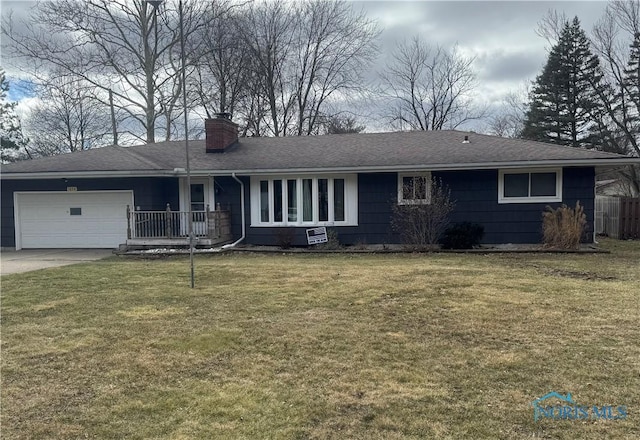 ranch-style home with a garage, driveway, a chimney, and a front yard