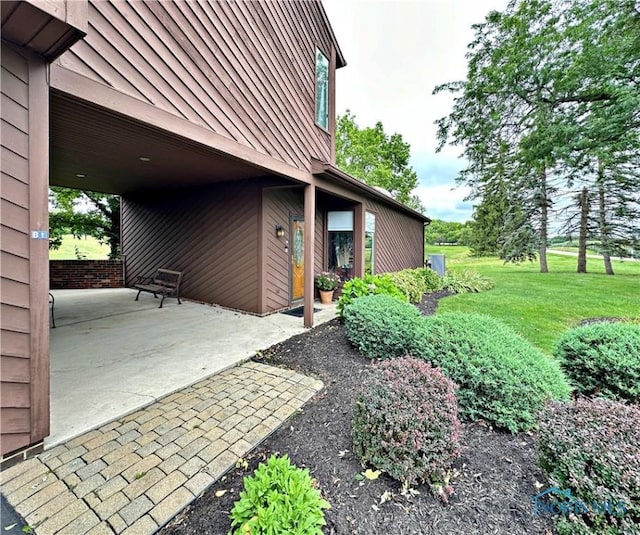 view of property exterior with metal roof, a patio, a yard, and a standing seam roof