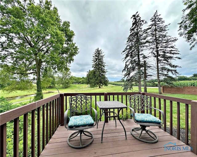 wooden deck featuring a yard