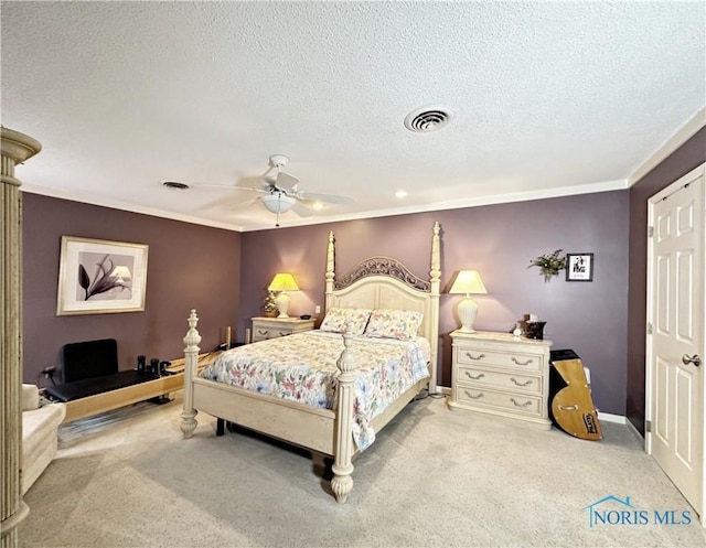 carpeted bedroom featuring visible vents, a textured ceiling, crown molding, and a ceiling fan