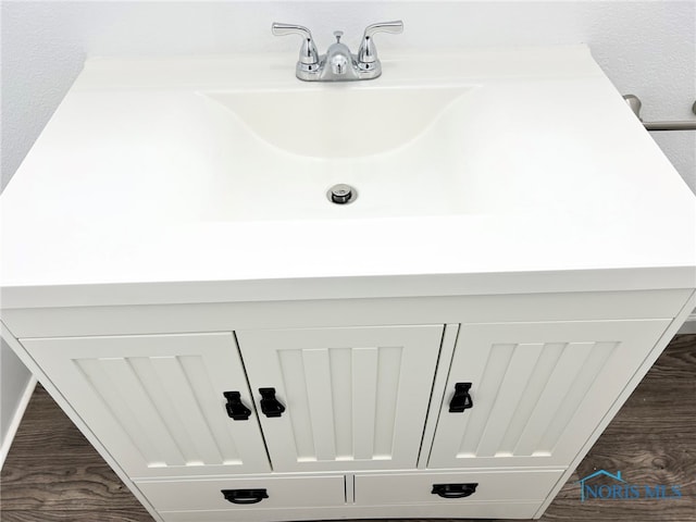 interior details featuring wood finished floors and a sink