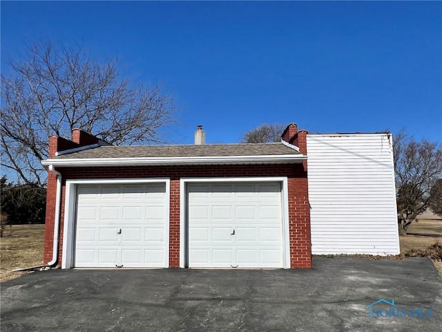 garage with aphalt driveway