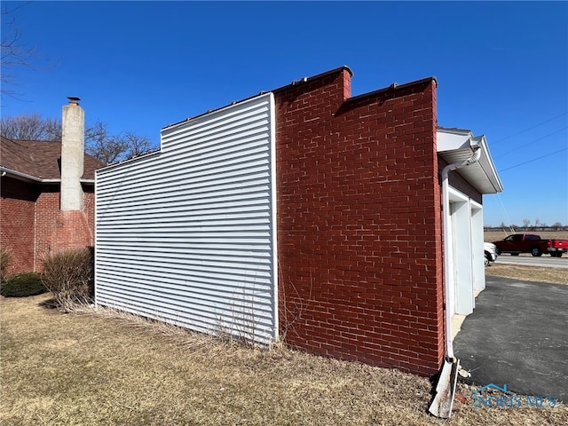 view of property exterior featuring brick siding