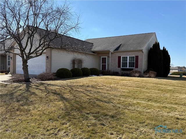 ranch-style home featuring a front lawn, an attached garage, and brick siding