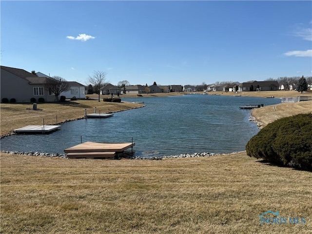 property view of water with a residential view and a boat dock