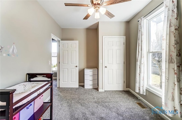 bedroom with carpet flooring, baseboards, visible vents, and ceiling fan