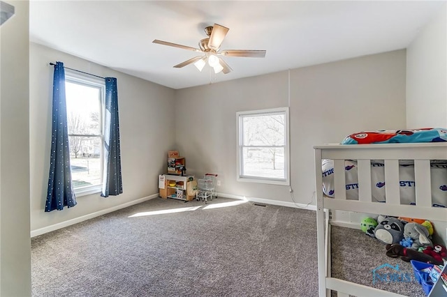 bedroom with multiple windows, baseboards, and carpet