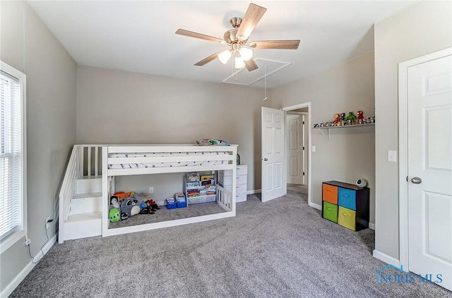 unfurnished bedroom with attic access, carpet, and baseboards