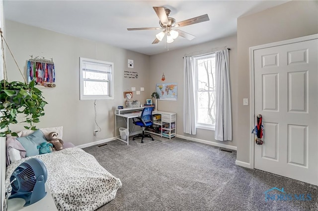 office area with carpet, baseboards, and ceiling fan