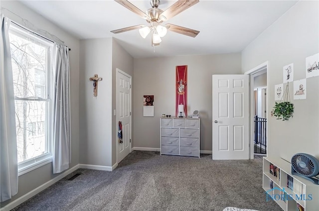 carpeted bedroom featuring visible vents, baseboards, and a ceiling fan