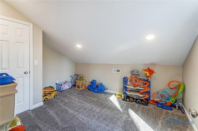 rec room with visible vents, carpet flooring, baseboards, and vaulted ceiling