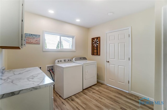 washroom featuring light wood-type flooring, recessed lighting, cabinet space, separate washer and dryer, and baseboards