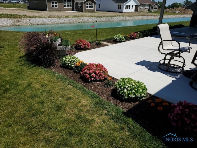 view of patio with a water view