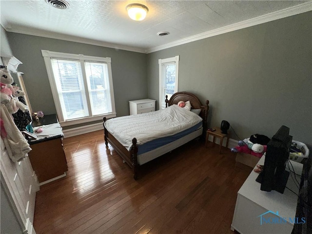 bedroom featuring crown molding, visible vents, and wood-type flooring