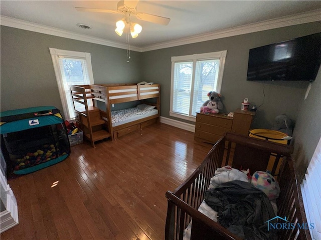 bedroom featuring visible vents, ornamental molding, and hardwood / wood-style flooring