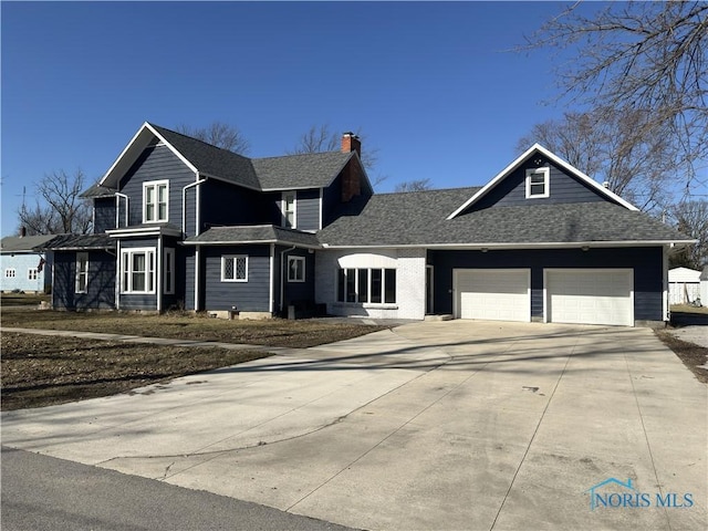 view of front of house with concrete driveway, an attached garage, roof with shingles, and a chimney