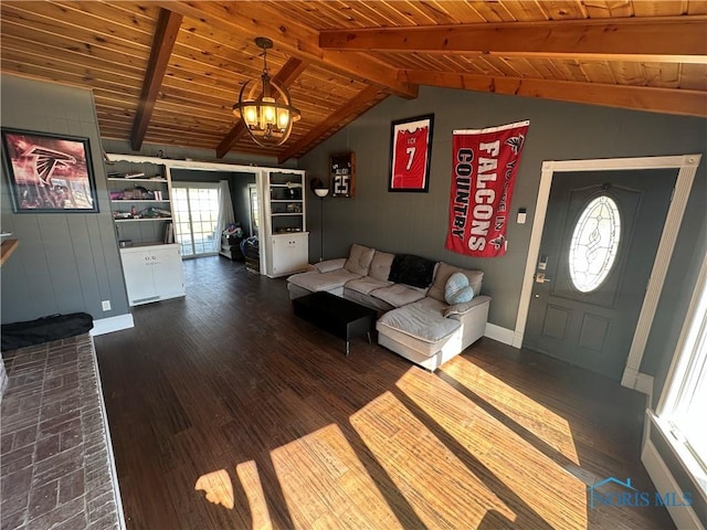 living area featuring baseboards, lofted ceiling with beams, wooden ceiling, a notable chandelier, and dark wood-style flooring