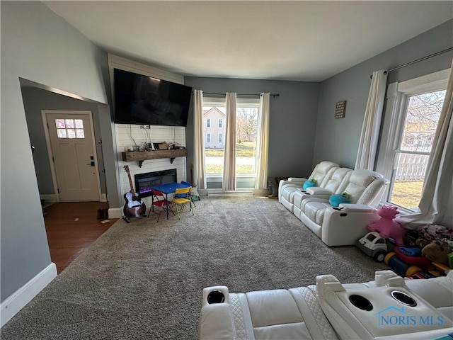 living room with carpet flooring, a fireplace, and baseboards