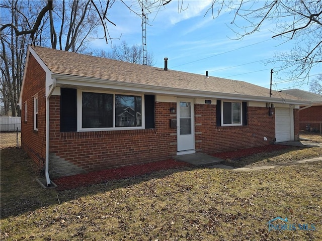 ranch-style home with an attached garage, fence, brick siding, and a shingled roof