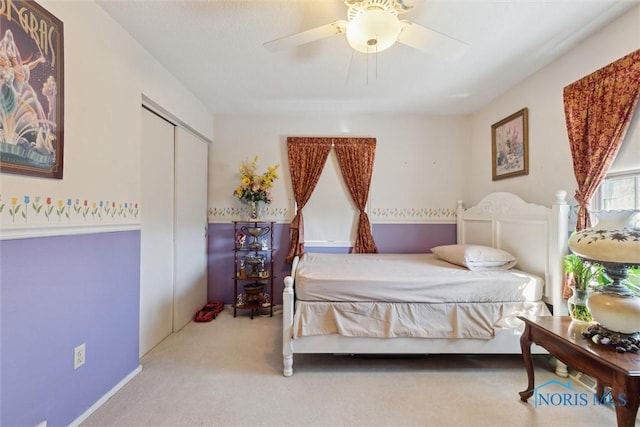 bedroom with a closet, a ceiling fan, and carpet flooring