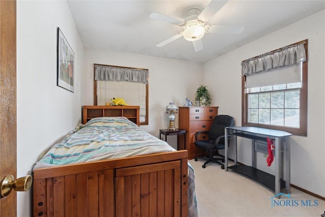 bedroom with light colored carpet, baseboards, and ceiling fan