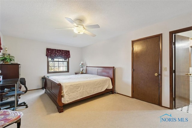 bedroom with a textured ceiling, a ceiling fan, baseboards, and light carpet