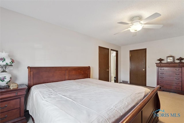 carpeted bedroom with a ceiling fan