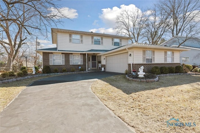 traditional-style home with brick siding, concrete driveway, and a garage